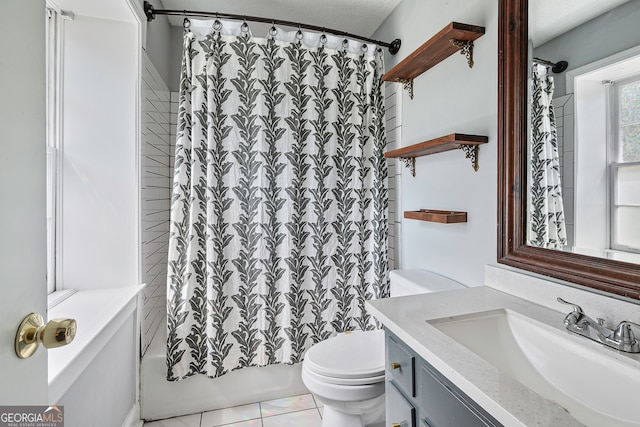 full bathroom with tile patterned floors, vanity, shower / bath combo, and toilet