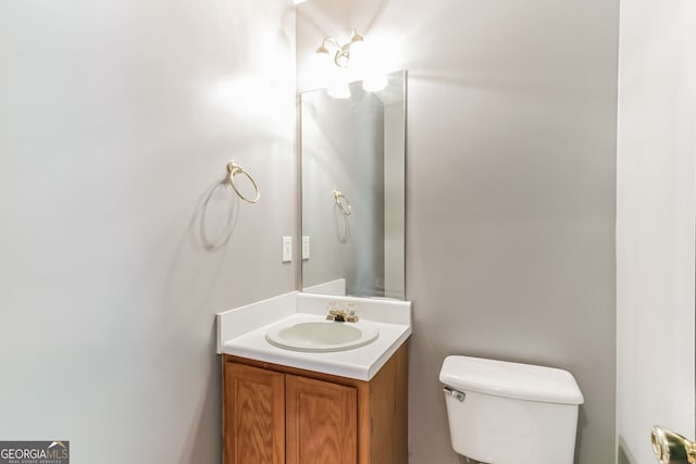 bathroom featuring toilet and vanity