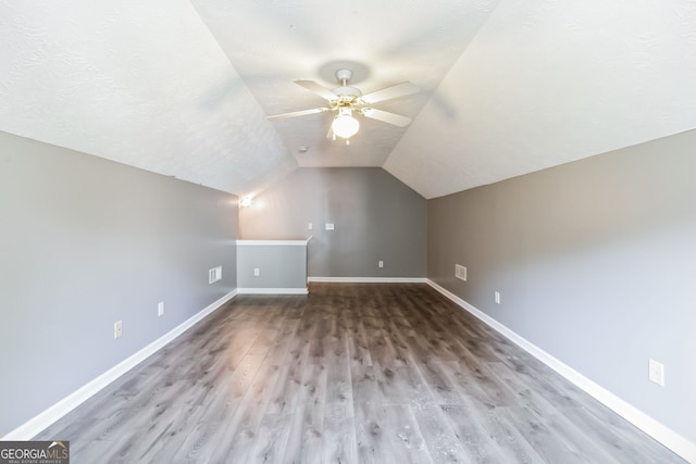 bonus room with ceiling fan, vaulted ceiling, and wood-type flooring