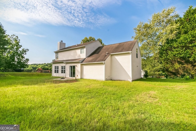 rear view of house with a lawn