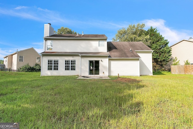 back of property with a patio area and a yard