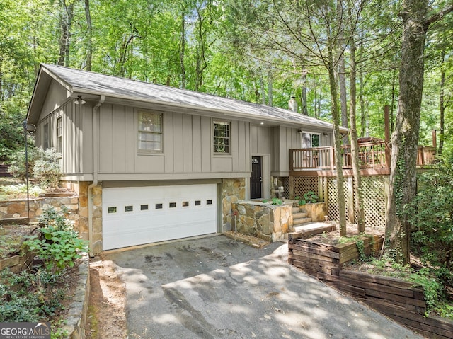 split foyer home featuring a garage and a deck