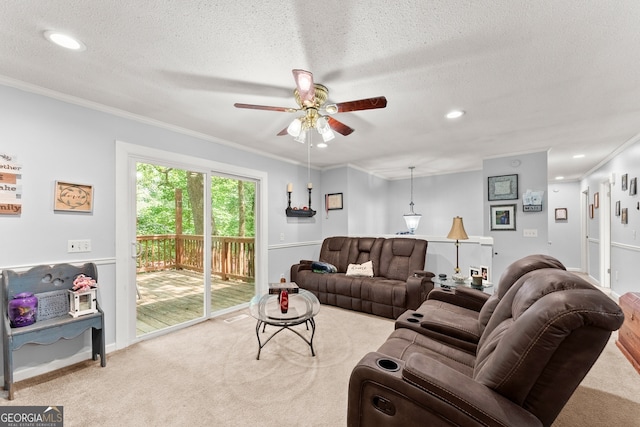 living room featuring ceiling fan, carpet, and crown molding