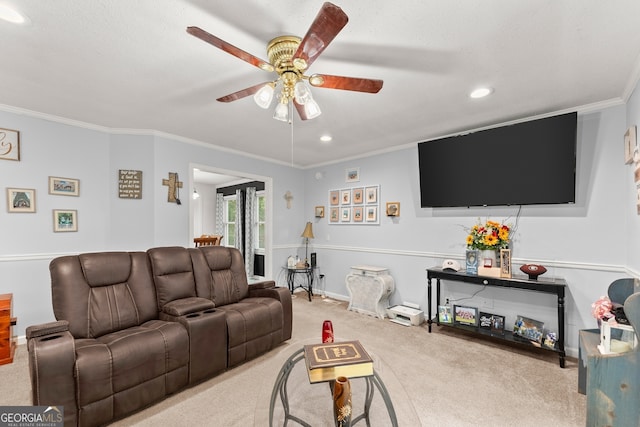 carpeted living room featuring ceiling fan and crown molding