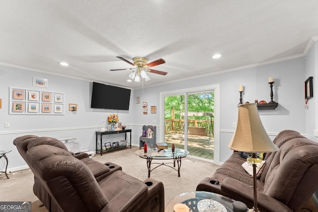 living room with a ceiling fan, baseboards, ornamental molding, a textured ceiling, and light colored carpet