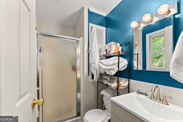 bathroom featuring a shower with shower door, tile walls, toilet, and vanity