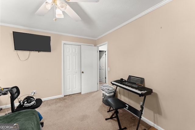 office space featuring ceiling fan, crown molding, and light colored carpet