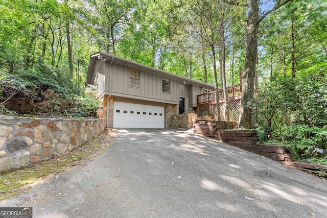 view of front of property featuring a garage and a wooden deck