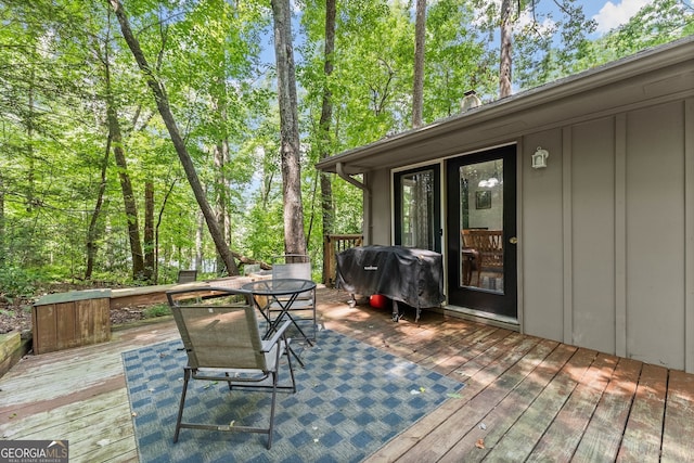 wooden deck with a grill