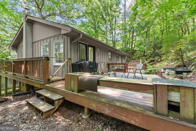 wooden deck with a grill