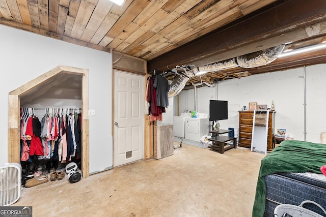 bedroom featuring washer and dryer, a closet, wood ceiling, and unfinished concrete floors