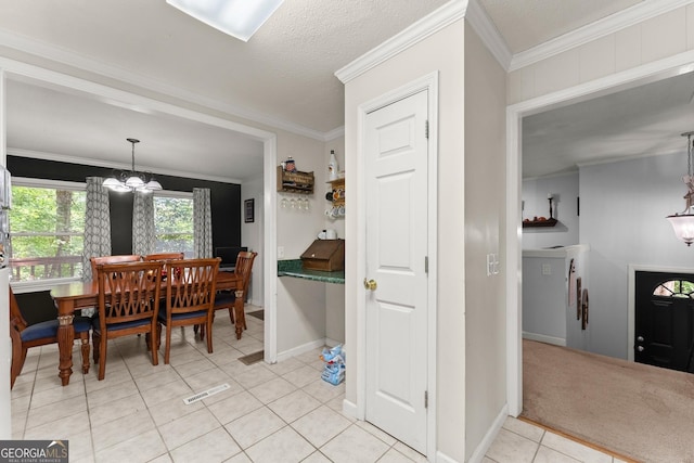 dining space featuring light tile patterned floors, visible vents, ornamental molding, a notable chandelier, and light colored carpet