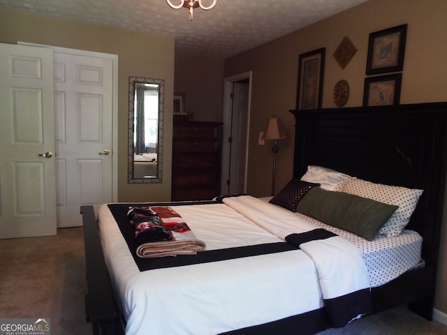 carpeted bedroom featuring a closet and a textured ceiling