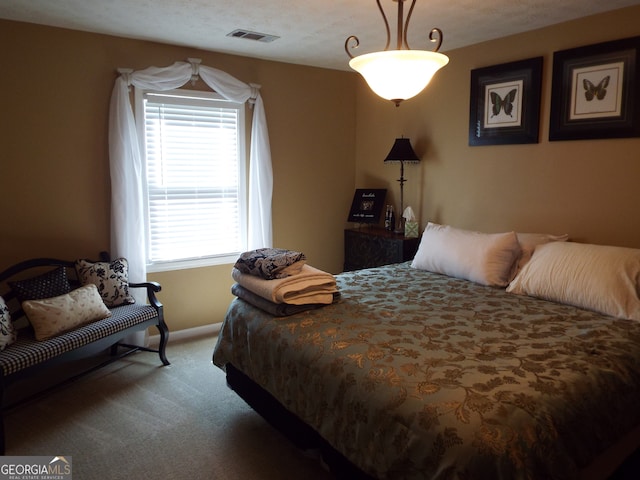 carpeted bedroom with a textured ceiling