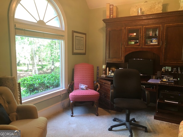 office area featuring lofted ceiling and carpet