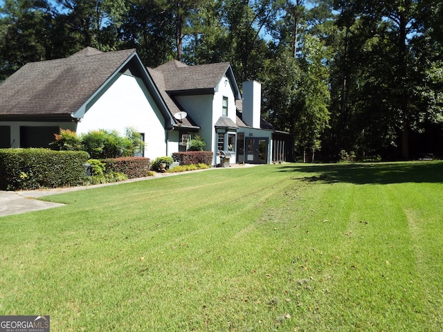 view of side of home with a lawn