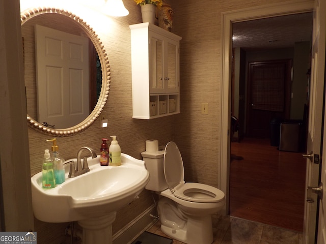 bathroom with toilet and tile patterned floors