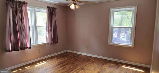 unfurnished room featuring hardwood / wood-style flooring and a healthy amount of sunlight