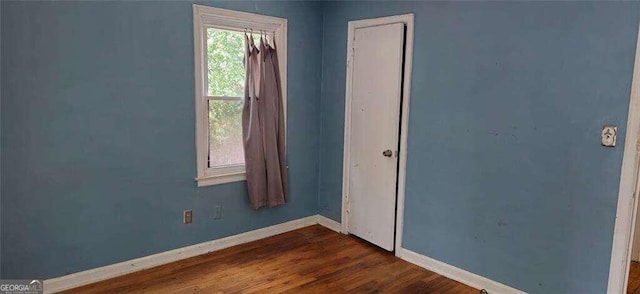 unfurnished room featuring hardwood / wood-style flooring