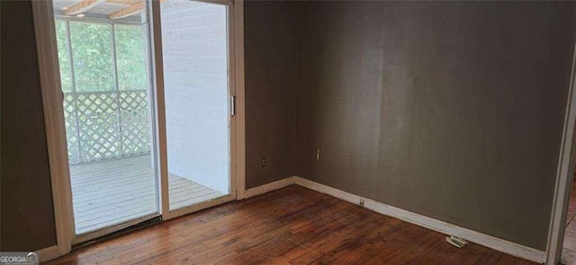 unfurnished room with hardwood / wood-style flooring