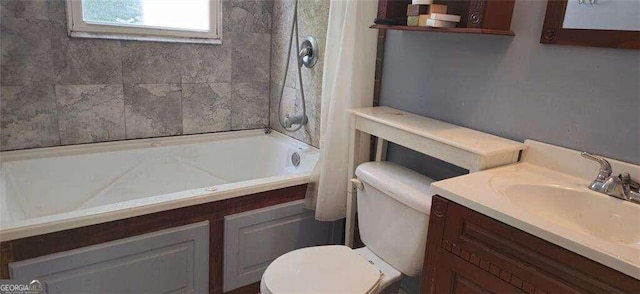 full bathroom with toilet, tiled shower / bath, and vanity