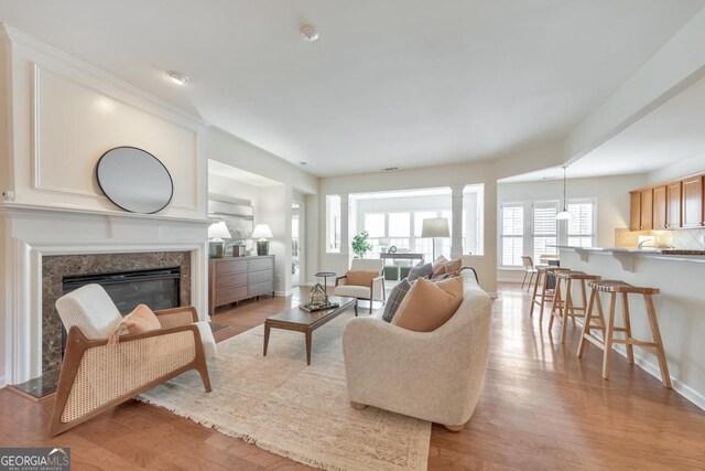 living room with crown molding and hardwood / wood-style floors