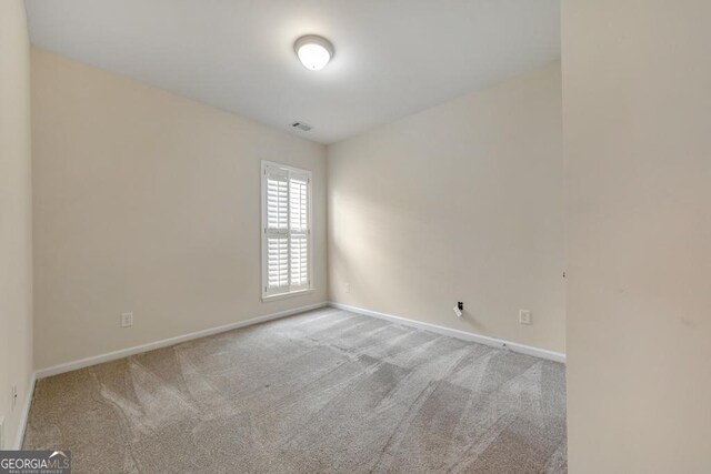 bedroom featuring crown molding, light carpet, and a tray ceiling