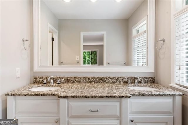 bathroom with vanity, a healthy amount of sunlight, and toilet