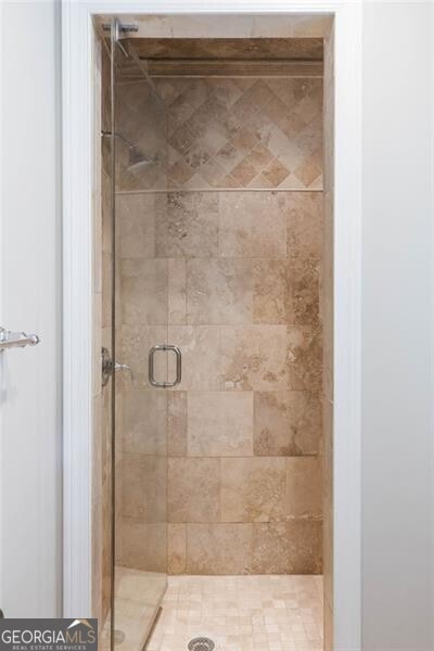 bathroom with a shower with shower door