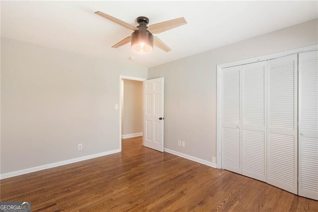 unfurnished bedroom with hardwood / wood-style flooring, a closet, and ceiling fan