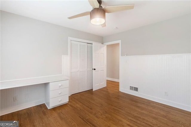 unfurnished bedroom featuring a closet, ceiling fan, and hardwood / wood-style floors