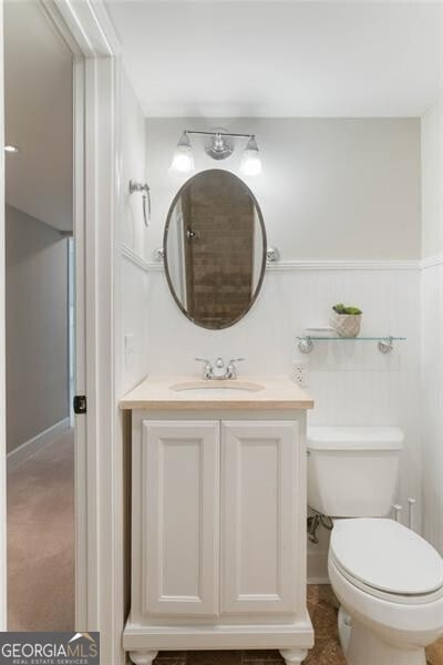 bathroom with toilet and vanity