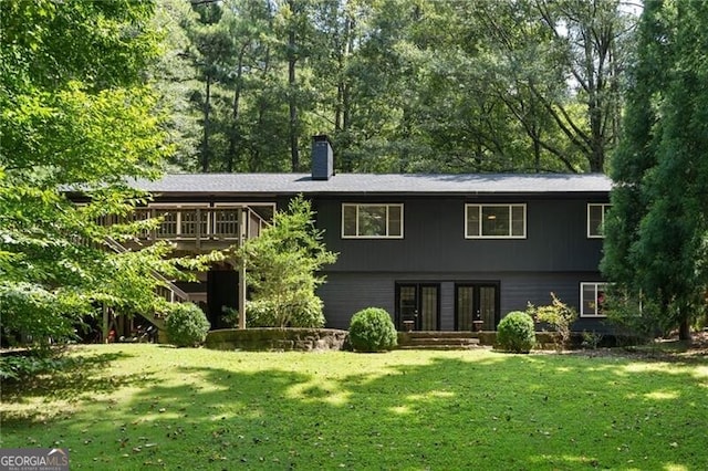 rear view of house with a yard