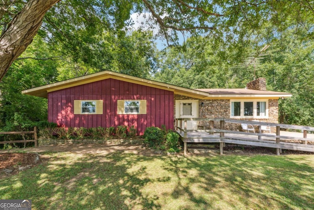 exterior space featuring a deck and a front yard