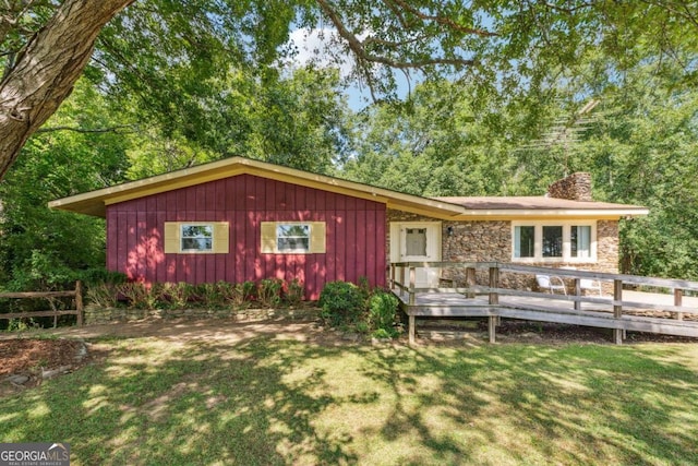 exterior space featuring a deck and a front yard