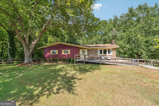 single story home with a front lawn and a deck