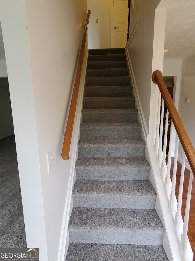 stairs featuring carpet floors