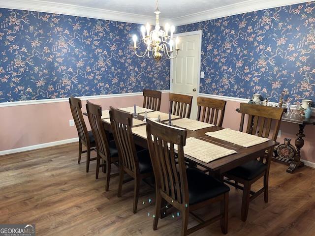 dining room with a chandelier, baseboards, dark wood finished floors, and crown molding