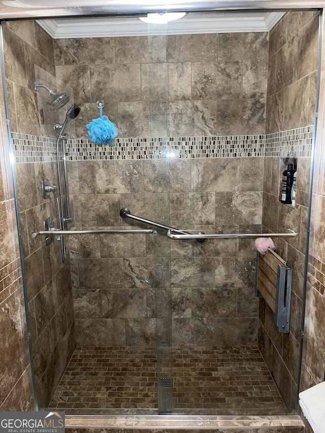 bathroom with a shower stall and crown molding