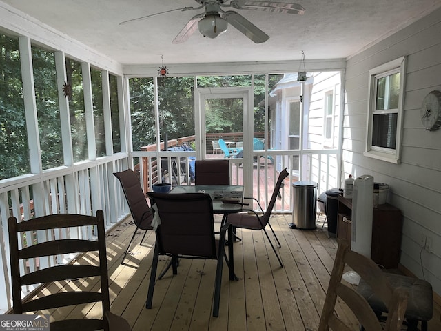 sunroom featuring a ceiling fan