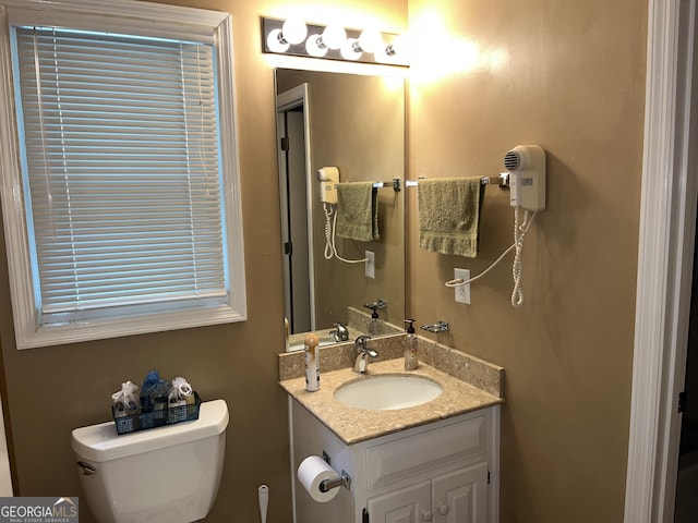 bathroom featuring toilet and vanity