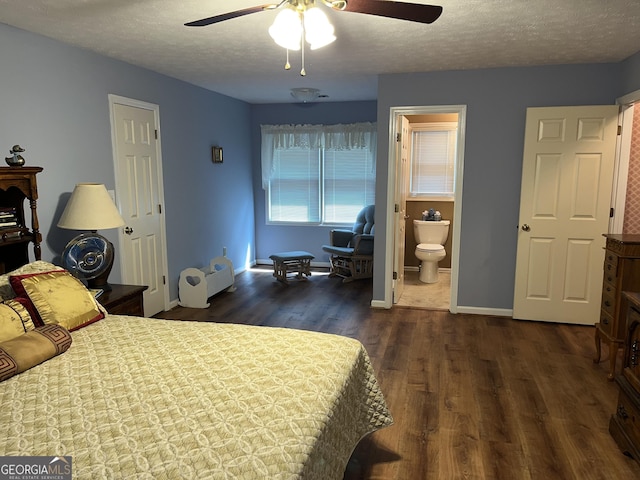 bedroom with a textured ceiling, dark wood-type flooring, a ceiling fan, baseboards, and ensuite bath