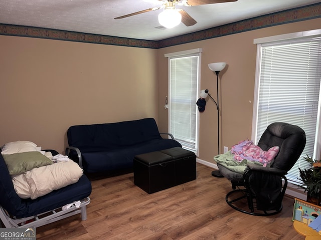 living room featuring ceiling fan and wood finished floors