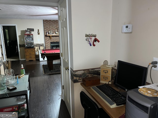 office featuring dark wood-style floors, pool table, and a textured ceiling