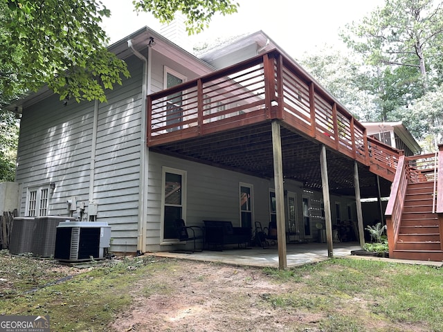 rear view of property with a patio area, stairs, central AC unit, and a deck