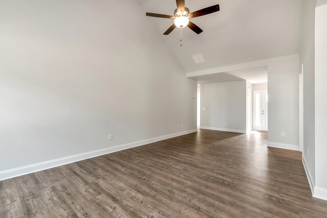 empty room with dark hardwood / wood-style floors, high vaulted ceiling, and ceiling fan