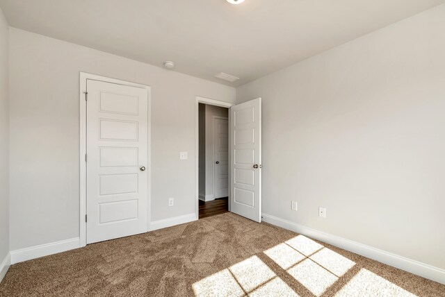 unfurnished bedroom featuring carpet flooring