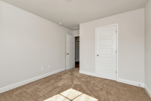 unfurnished bedroom with carpet flooring and a closet