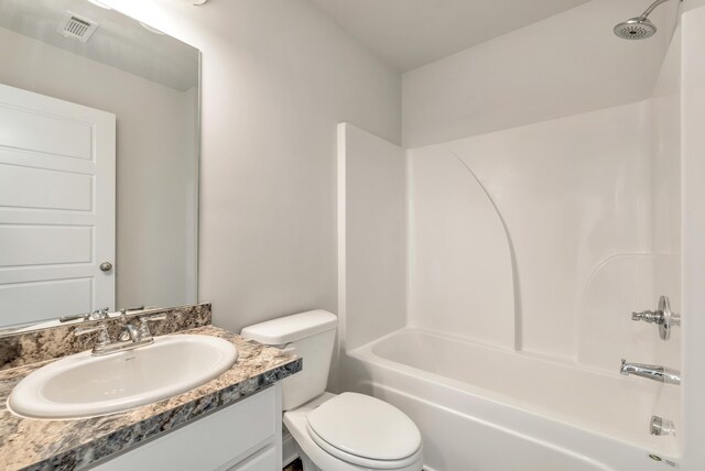 full bathroom featuring vanity, bathtub / shower combination, and toilet