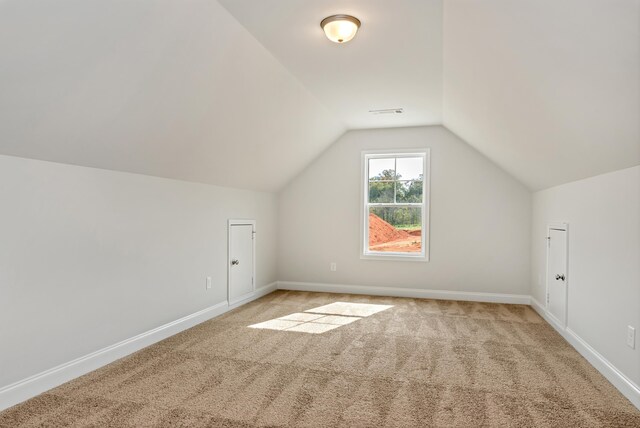 bonus room featuring carpet flooring and vaulted ceiling